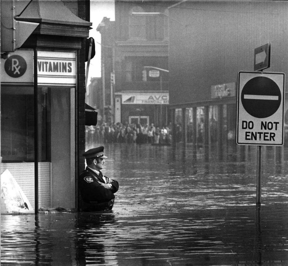 pappito:“ruihenriquesesteves:“Police officer guarding a pharmacy in high-flood waters, Ontario, 1974”Megaboss”