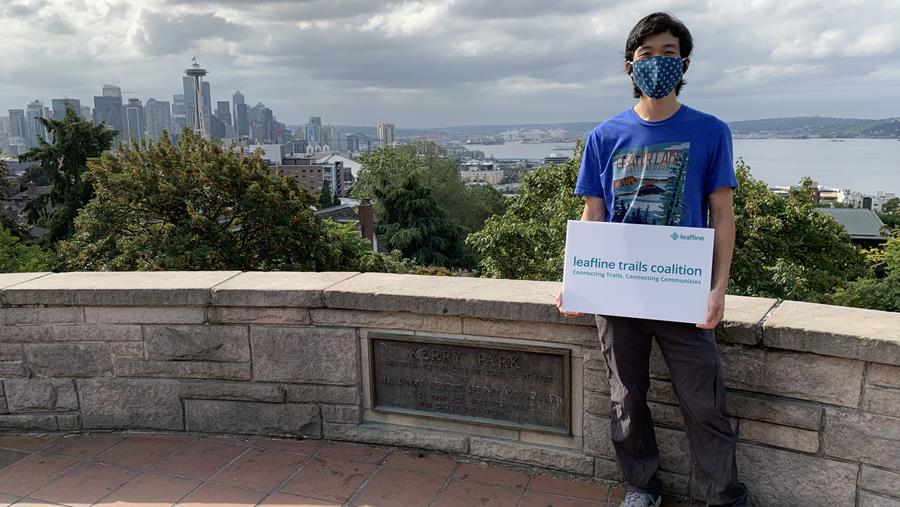 Chris Liu with Leafline sign at Kerry Park