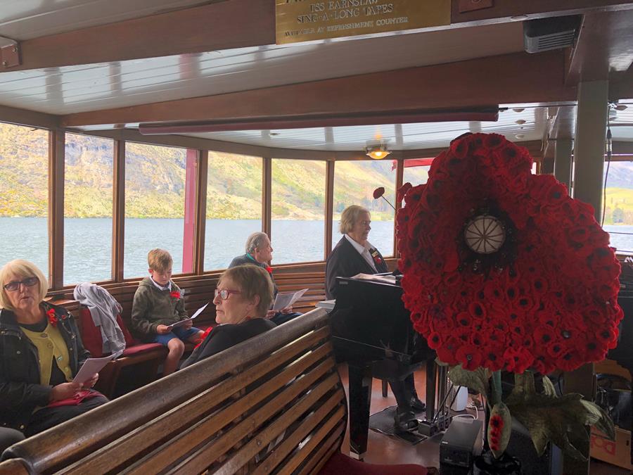 At 11.02am the TSS Earnslaw sounded its horn on Lake Wakatipu and pianist Eleanor Muir led passengers in the national anthem and old war songs. Image provided by Tsehai Tiffen.