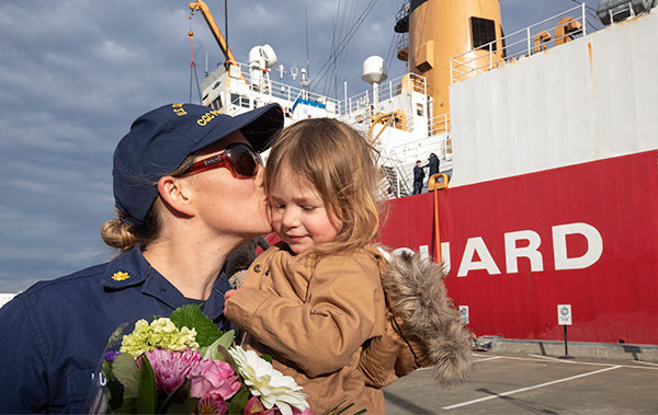 Lt. Commander Karen Kutkiewicz kisses her daughter