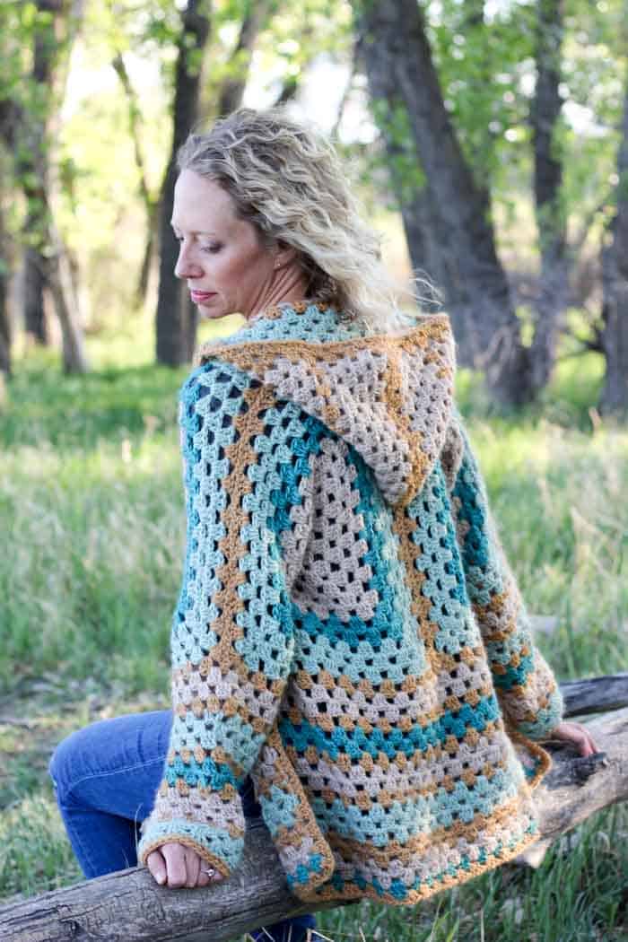 Believe it or not, two simple granny hexagons are the foundation of this free crochet hexagon sweater pattern. The Campfire Cardigan is made with Lion Brand New Basic 175 in Juniper, Cafe Au Lait, Thyme and Camel. Easily make this modern boho crochet sweater pattern!