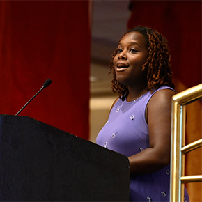 African American woman speaking at podium