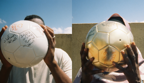 Sudanese refugees holding footballs with slogans like 'Stop the war in Sudan' written on them.
