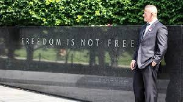 A photo of Richard standing before the Korean War Veterans Memorial in Washington D.C. which reads: “Freedom is not free.” A photo of Richard standing before the Korean War Veterans Memorial in Washington D.C. which reads: “Freedom is not free.”