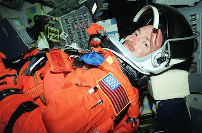 Picture of Mark wearing his astronaut suit, taken in a space shuttle.