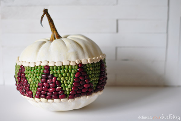 s 13 popular ways to decorate a pumpkin with little or no carving, Cover it with beans for a vibrant look