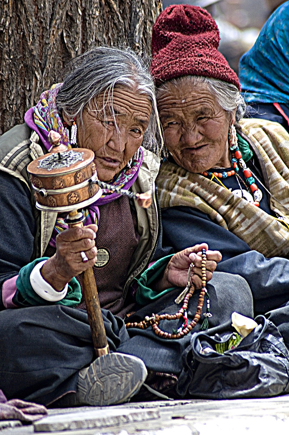 Two locals, one with a Buddhist prayer wheel. Photo: Tim Pile