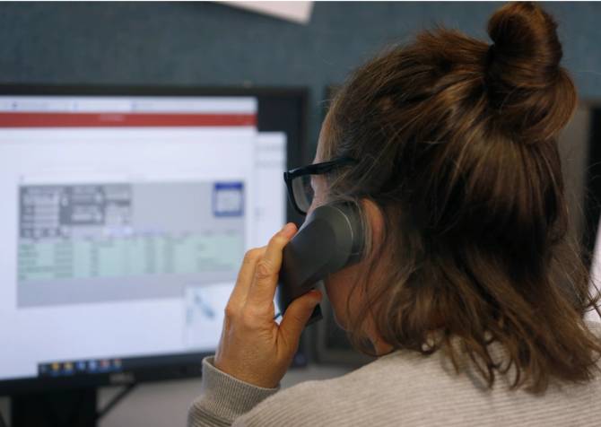 Call center operator answers a call from a client on a suicide hotline at Crisis Support Services of Alameda County in Oakland, Calif. on Tuesday, April 14, 2020. 