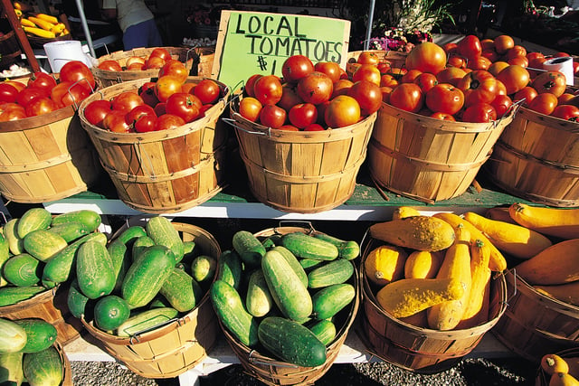 Local vegetables in buckets on a farmer's market table