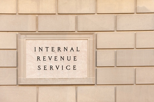 Internal Revenue Service in a plaque on a beige brick wall