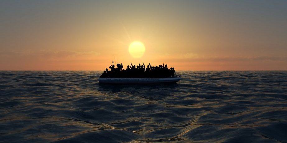 116523880 - refugees on a rubber boat in the middle of the sea that require help. sea with people asking for help. migrants crossing the sea