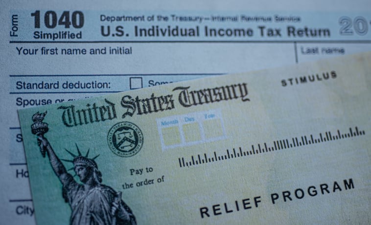 Close up of an Economic Impact Payment check and 1040 tax form