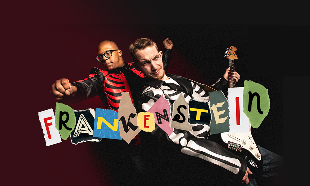 Two people in skeleton outfits posing with "Frankenstein" in colorful cutout letters.