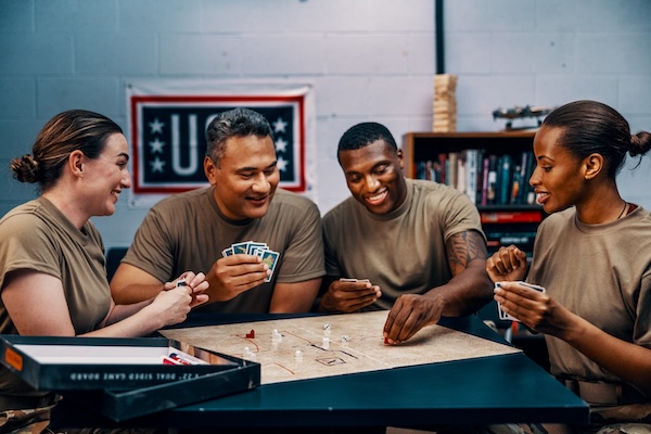 Service members playing video games and card games at USO Centers. Service members playing video games and card games at USO Centers.