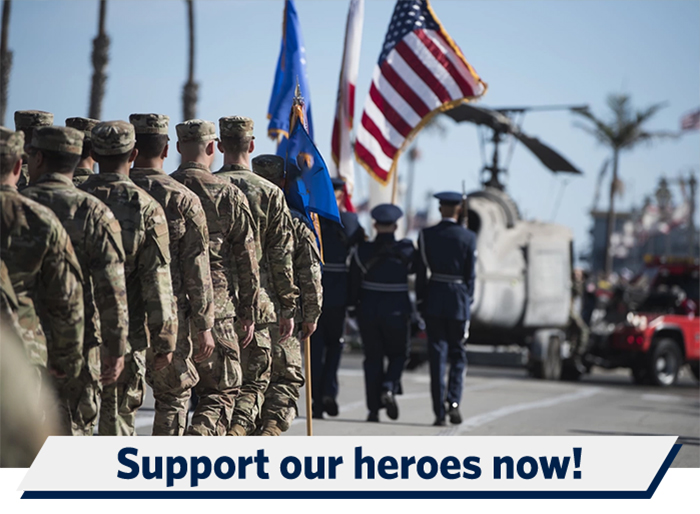 Airmen marching in rows behind Airmen holding flags Airmen marching in rows behind Airmen holding flags