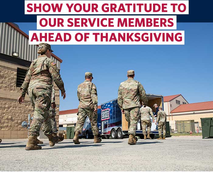 Service members walking toward USO delivery truck. Service members walking toward USO delivery truck.