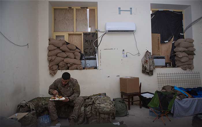 Service member eating a meal by himself overseas Service member eating a meal by himself overseas