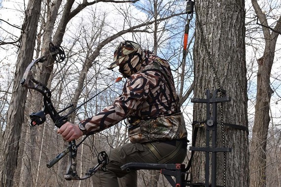 Archer wearing harness in tree stand