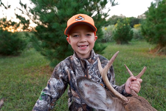 Young boy with his first deer (a buck)