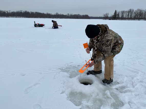 Ice fisherman on the ice setting up