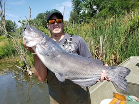 A man holding a fish in both hands.