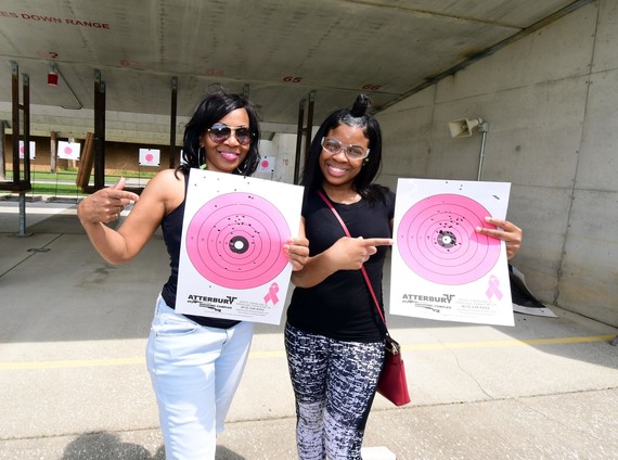 Two women holding their targets.