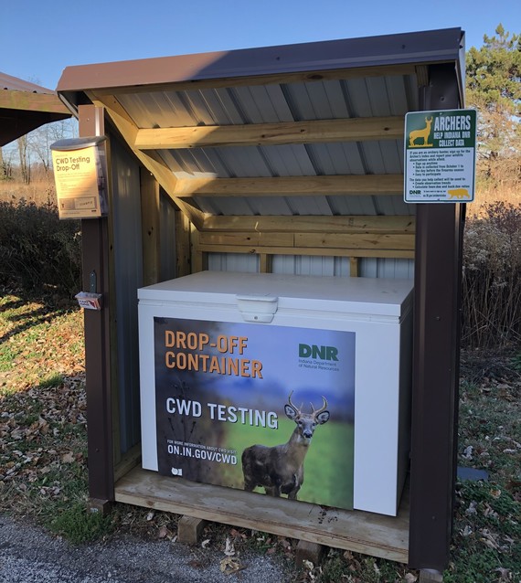 A container labeled “Drop Off-Container: CWD Testing” with a photo of a deer on it.