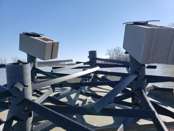 A Mossback structure held down by weights.