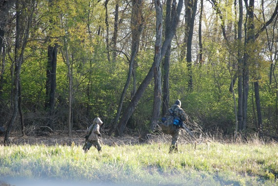 A father and son hunting in a field.