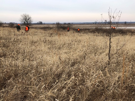 A group of hunters in a field.