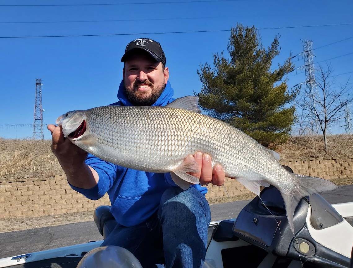 A man holding a whitefish.
