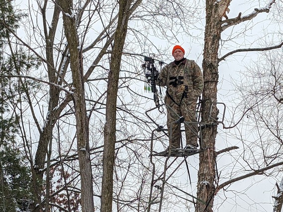 Getz in a tree stand in the woods.