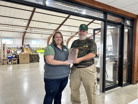 Two people standing next to each other and smiling.