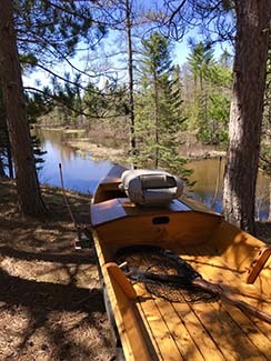 A drift boat sits waiting and ready for a trip on the Manistee River.