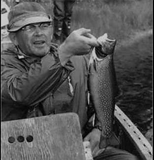 A historic photo shows Clarence Roberts with one of his many trout catches.
