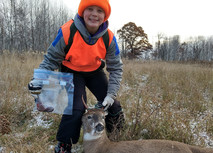 kid who harvested a deer holding spleen in a zip-close bag