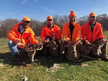 firearms deer hunters holding bucks they harvested