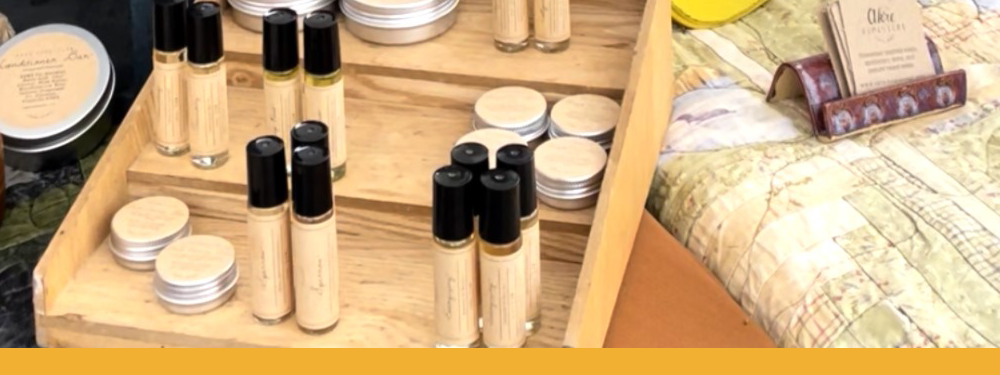 closeup of a vendor booth displaying handmade beauty and self care products.