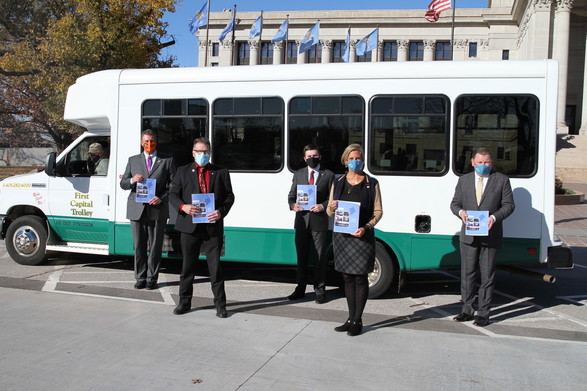 Leaders standing with First Capital Trolley bus