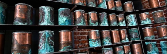 photo of old copper urns on a shelf