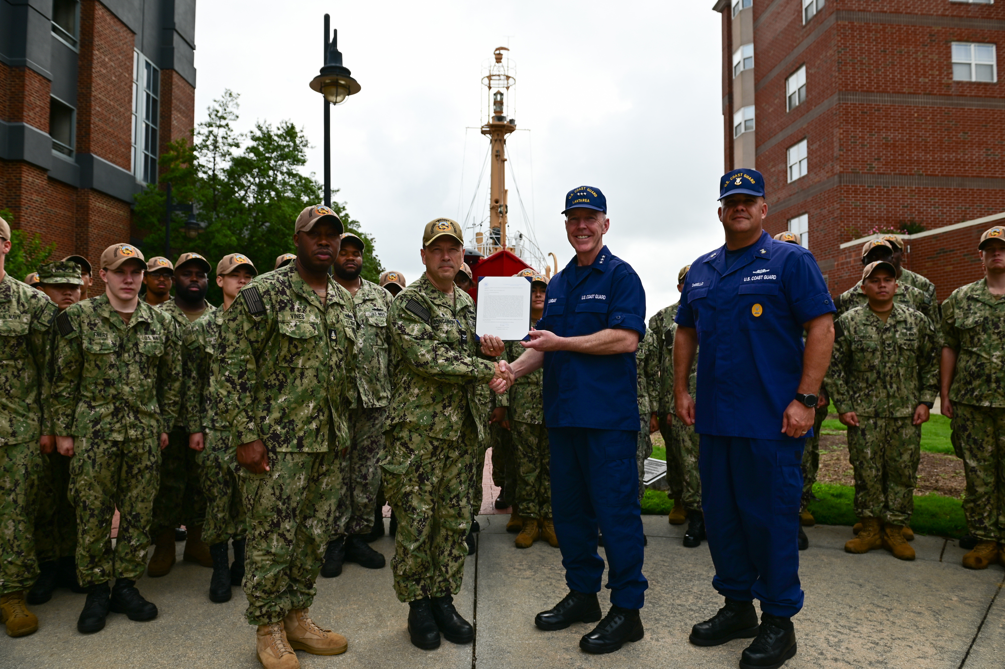 Vice Adm. Kevin Lunday presents the Coast Guard Special Operations Service Ribbon to the crew of USS Hershel 