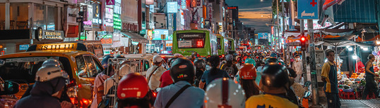 photo of busy street in Vietnamese city with lots of people and cars