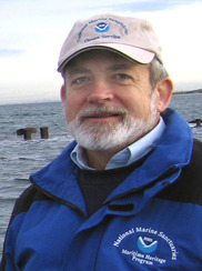 John Broadwater, white male with gray beard wearing a NOAA hat and blue jacket