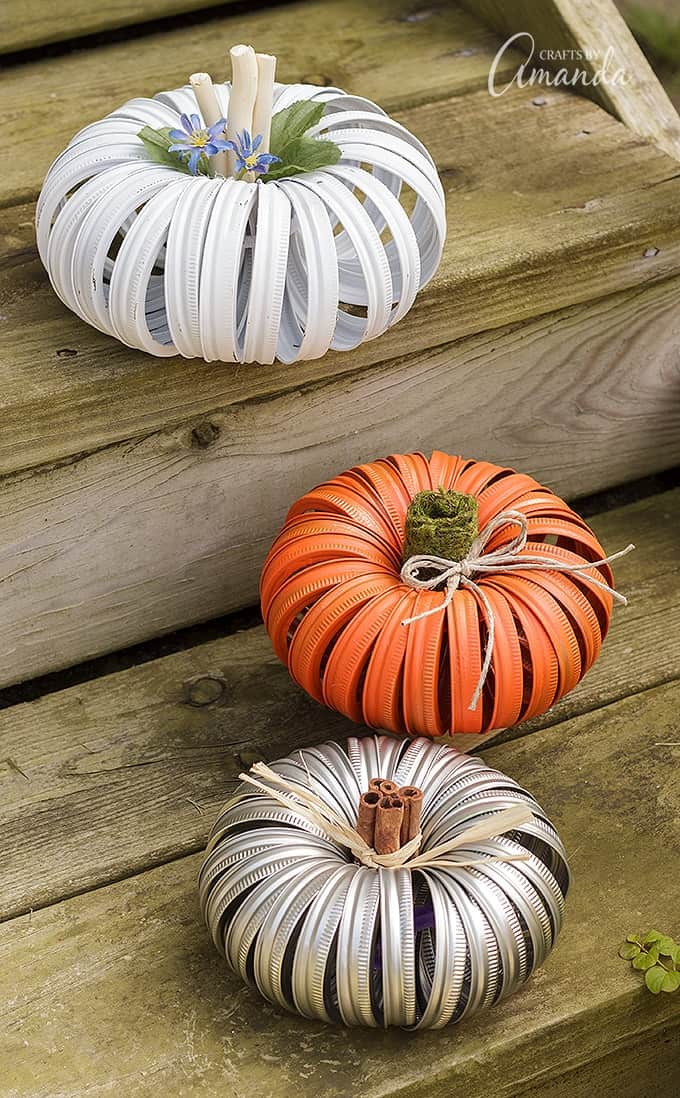 Pumpkins made out of canning lids from mason jars sitting stairs