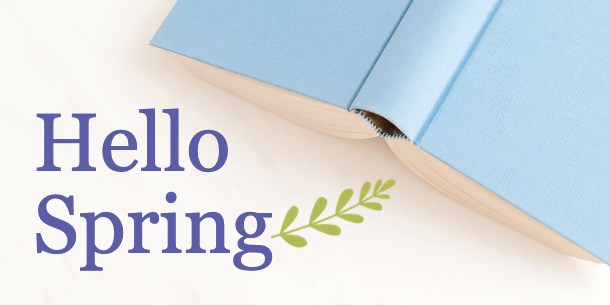 Blue Open Book on White Background with Leaves on Branch with Hello Spring Text