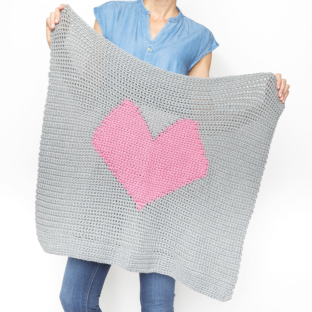 This easy baby blanket is fun to work on and full of love. This free crochet pattern would make a sweet gift for a family friend or even donate one to the local hospital. #CrochetBabyBlanket #EasyCrochetBabyBlanket #BabyBlanketPattern