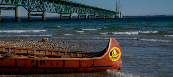 One of the Little Traverse Bay Bands of Odawa canoes at the Pipe Out Paddle Up Floatilla Against the Line 5 pipeline in Mackinaw City, Michigan, on Saturday, September 3, 2022. (Sarah Rice for Earthjustice)