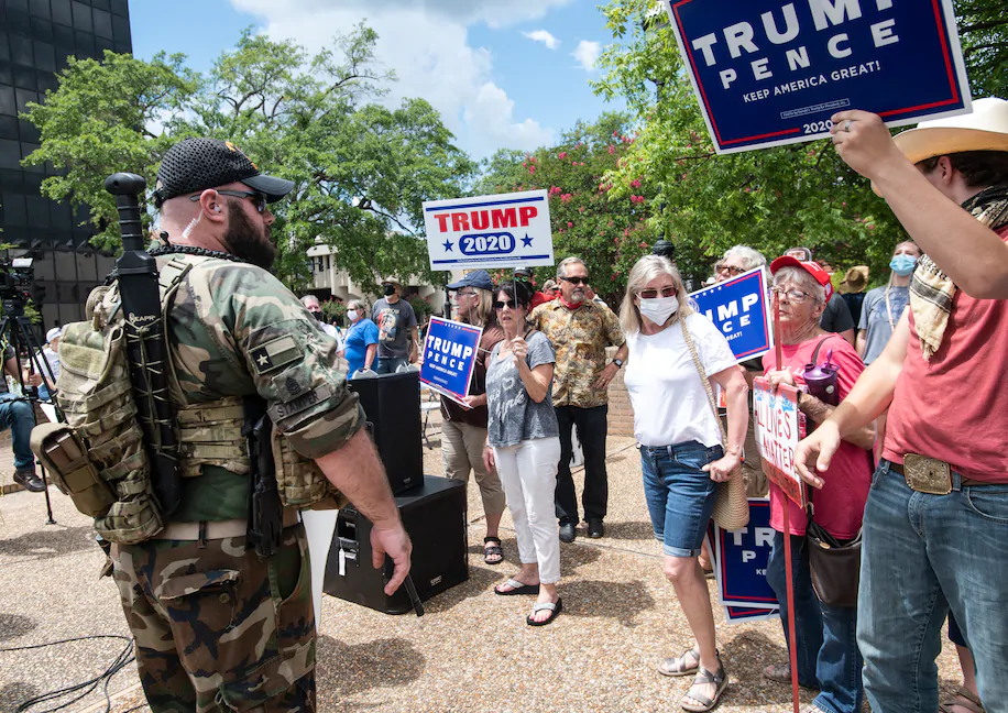 Washington Post: "Armed men push a crowd back after a fight broke out in downtown square in Tyler, Tex., whoen two opposing groups clashed on July 26. (Sarah A. Miller/AP)"
