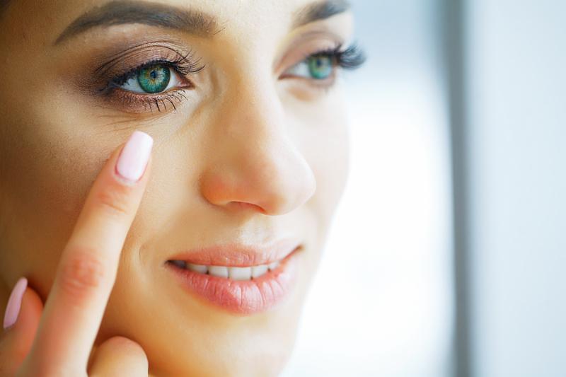 Health. Young Girl Holds Contact Lens In Hands. Portrait of a Beautiful Woman with Green Eyes and Contact Lenses. Healthy Look. High Resolution