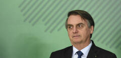 Brazilian President Jair Bolsonaro attends a ceremony to sanction a law that will offer lower bank rates for people who do not have debts, at Planalto Palace in Brasilia, on January 12,  2019. - Brazilian President Jair Bolsonaro on Monday sacked his education minister, an ultraconservative who had drawn public ire over a range of controversial proposals including a revision of school textbooks to deny the 1964 military coup. (Photo by EVARISTO SA / AFP)